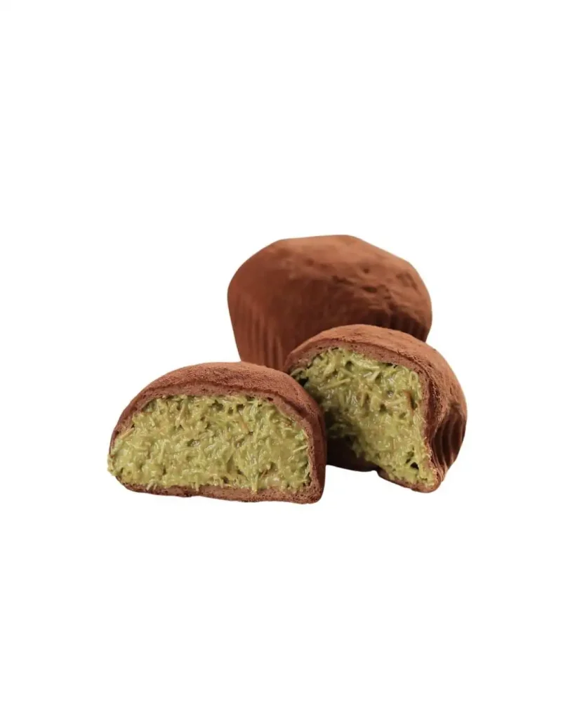 Dubai chocolate truffle cut open showing pistachio knafeh kataifi filling inside cocoa dusted shell